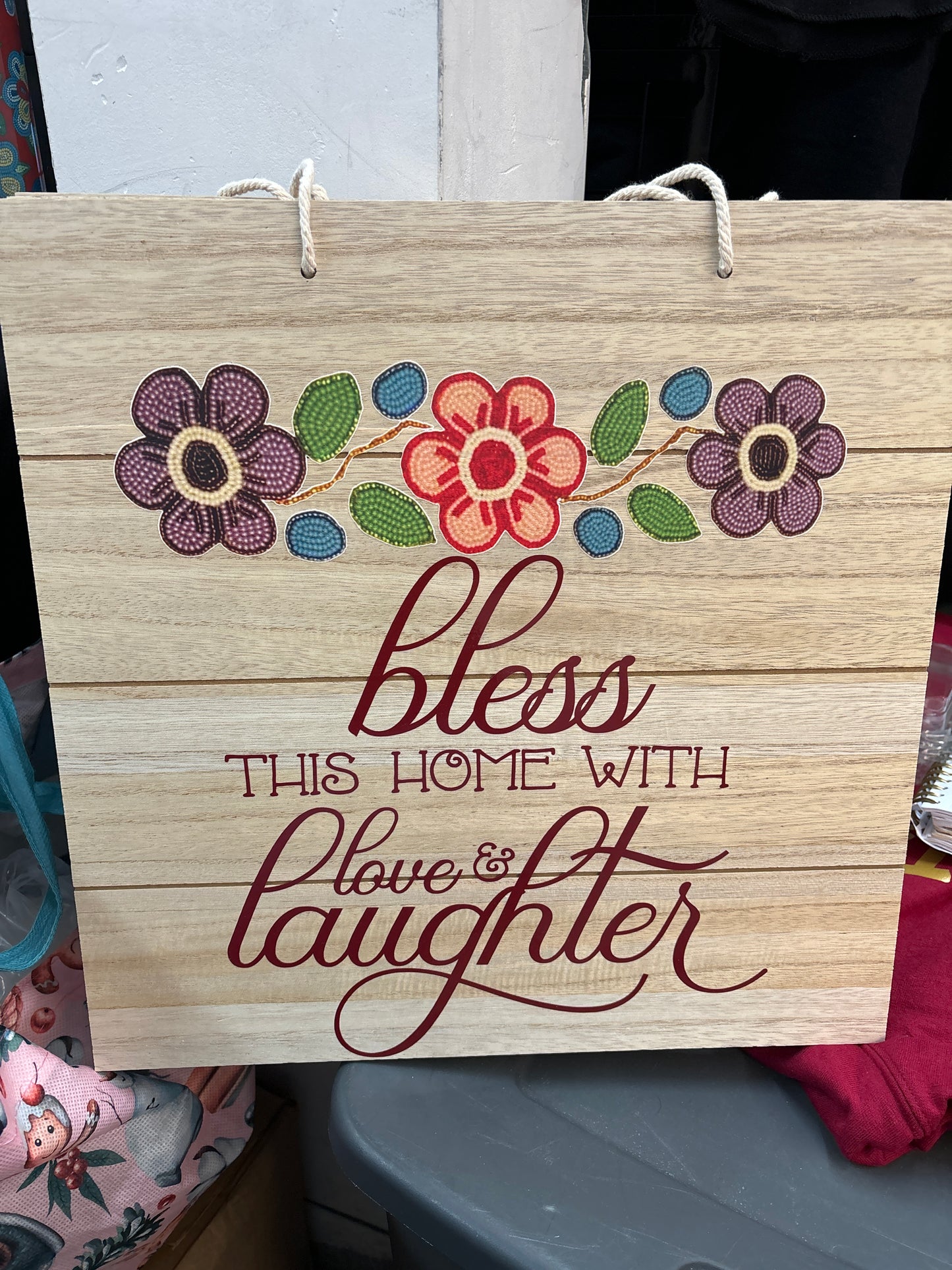 Wall hanging “bless this home with love and laughter”