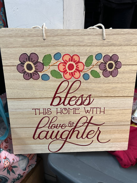 Wall hanging “bless this home with love and laughter”